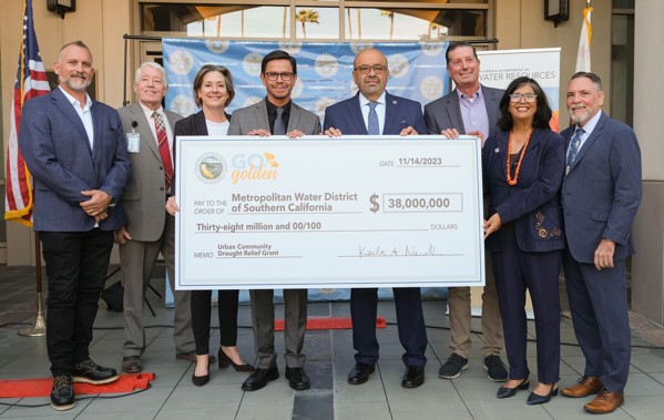 A group photograph of the Urban Community Drought Relief Program Check Presentation.