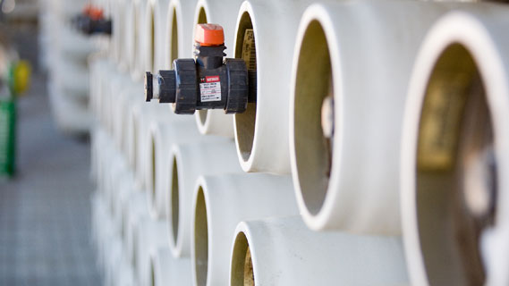 Stacked cylinders with a spiggot protruding out of one used in water recycling